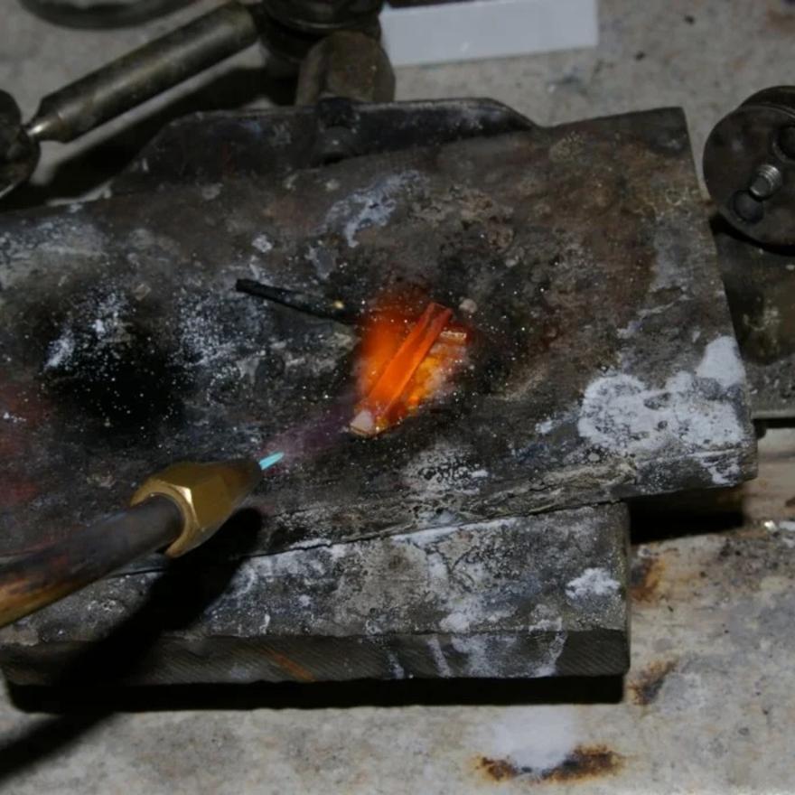 Preparing metal for working by annealing.