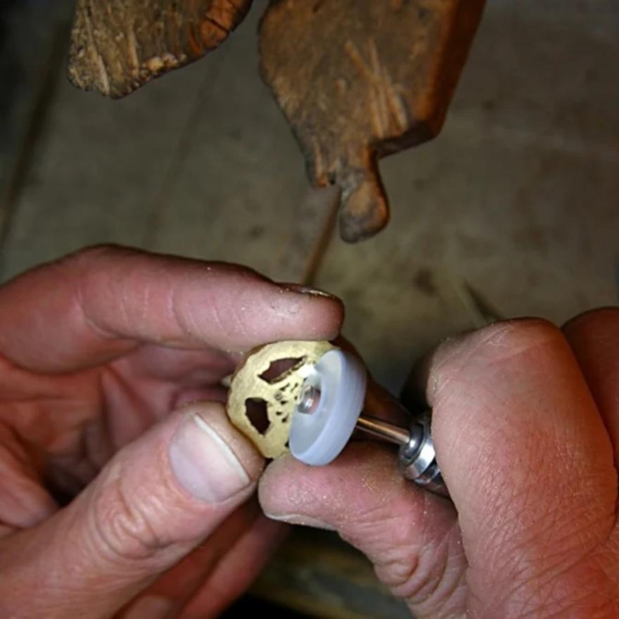 Removing burs of metal with a stone wheel.
