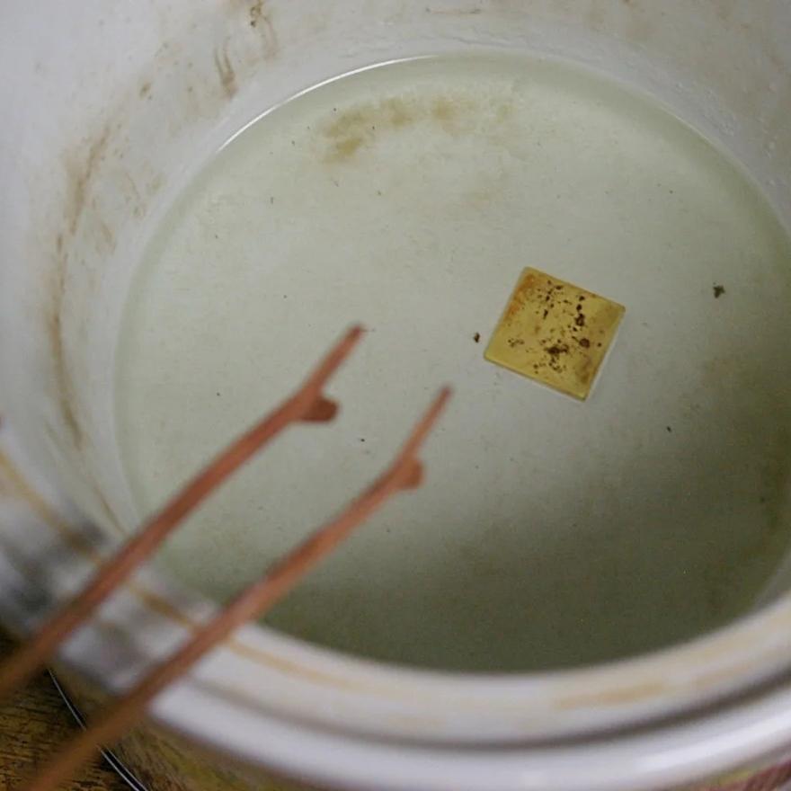 Once gold has been heated with a protective agent to prevent oxidation, it must be cleaned in a hot acid bath.